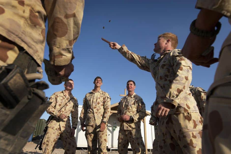  Australians soldiers playing two-up in Afghanistan, 2011 (ABC Licensed: CPL Ricky Fuller, Department of Defence)