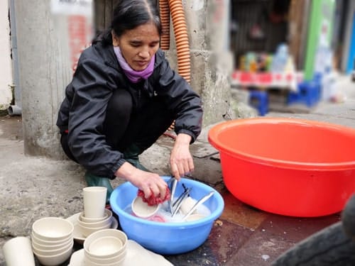 Bà Vũ Thị The, mẹ của Nguyễn Vũ Linh là lao công trong một ủy ban phường và lau dọn, rửa bát trong quán ăn. Ảnh: Quỳnh Trang.