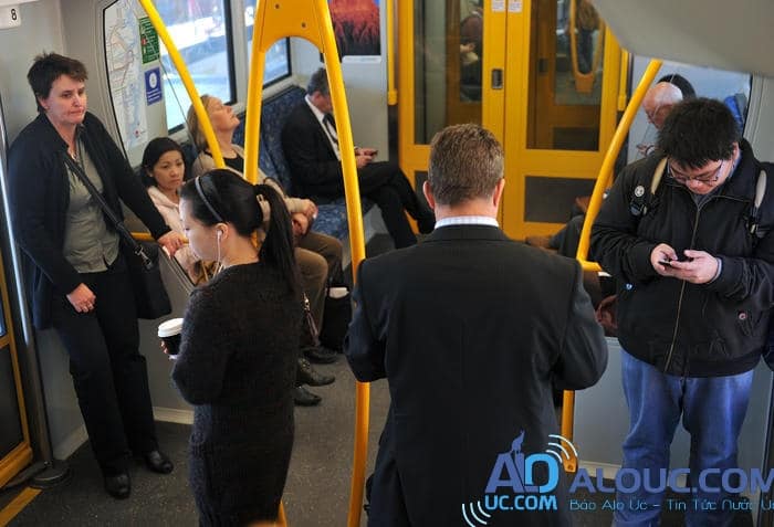 Commuters ride a city train in Sydney on Tuesday, May 15, 2012. (AAP Image/Paul Miller) NO ARCHIVING