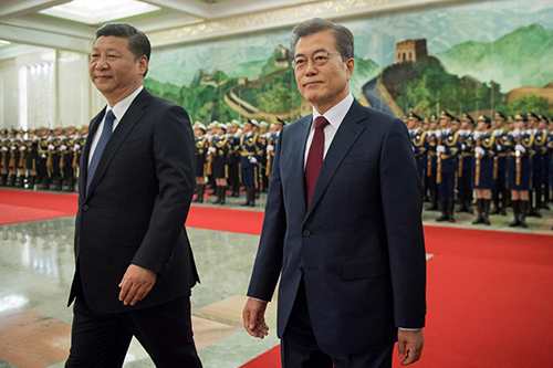 South Korean President Moon Jae-In and Chinese President Xi Jinping review the Chinese honour guard during a welcome ceremony at the Great Hall of the People in Beijing, China December 14, 2017.