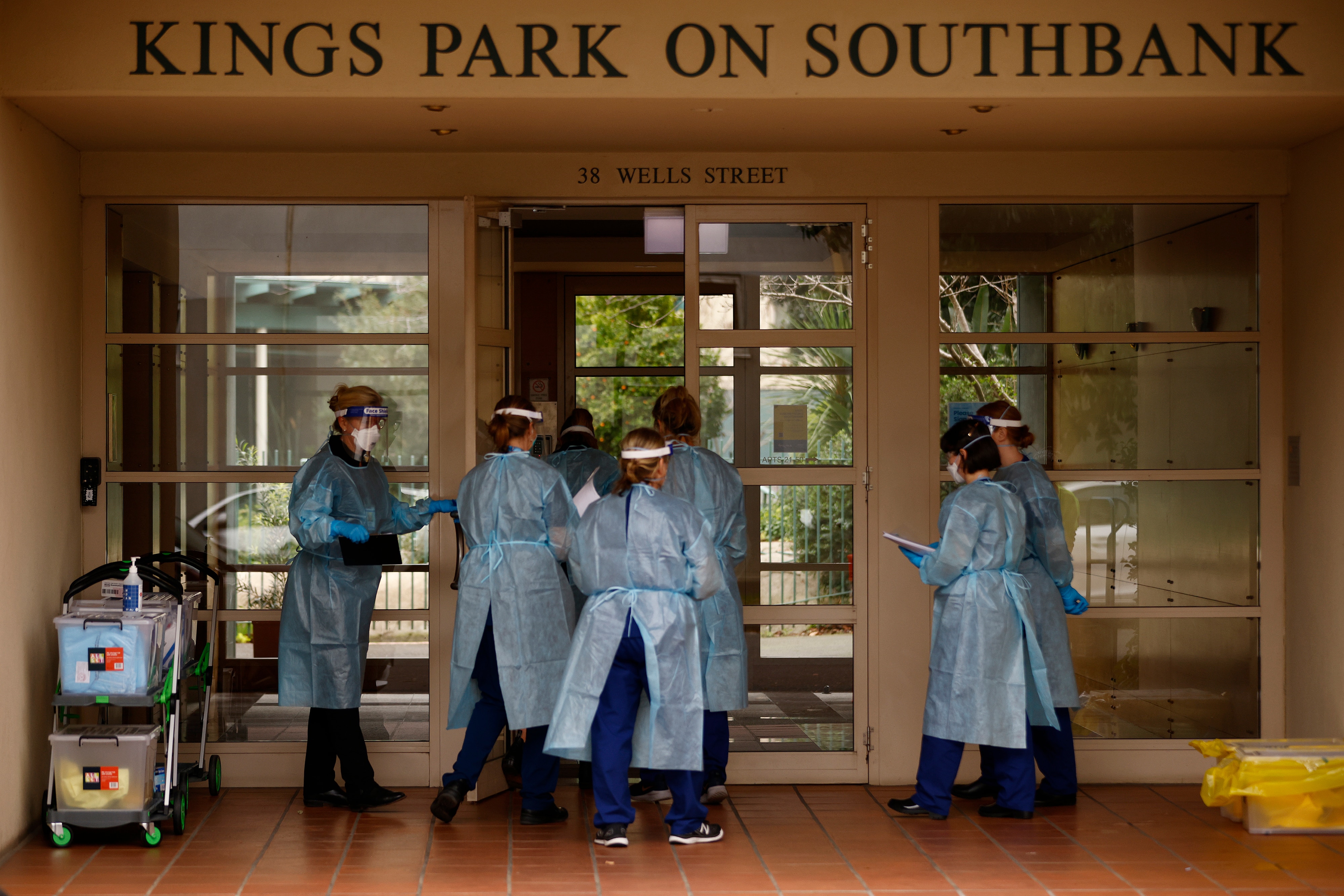 COVID-19 testing staff entering the Kings Park on Southbank apartment building, in Melbourne, Tuesday, 15 June, 2021. 