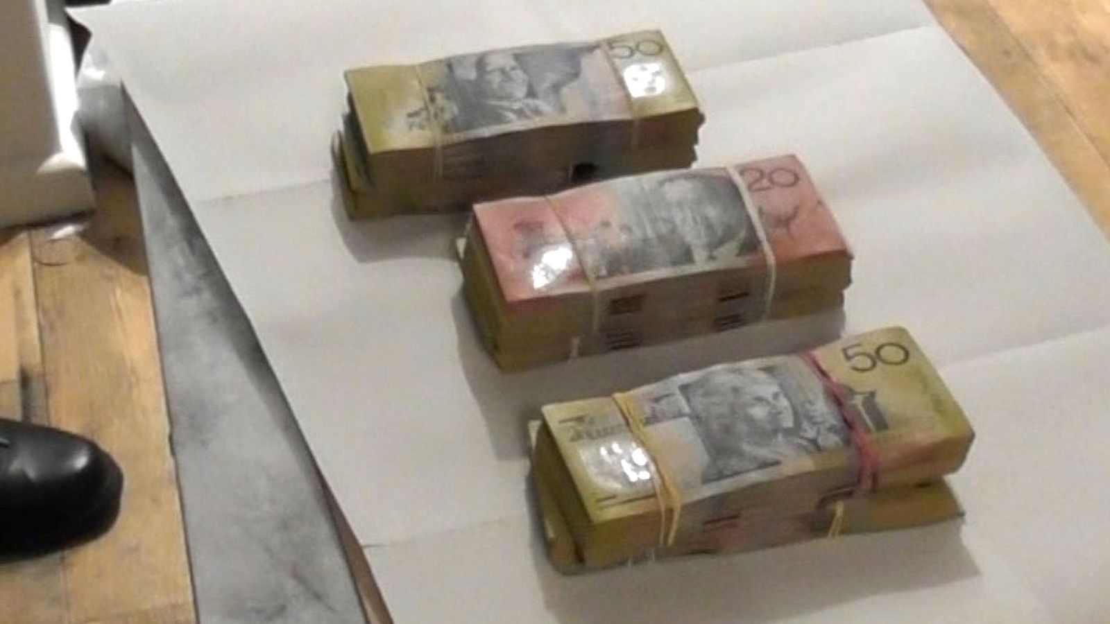 During a search, officers located and seized almost $1.15 million in cash – some of which was found in a grocery bag.