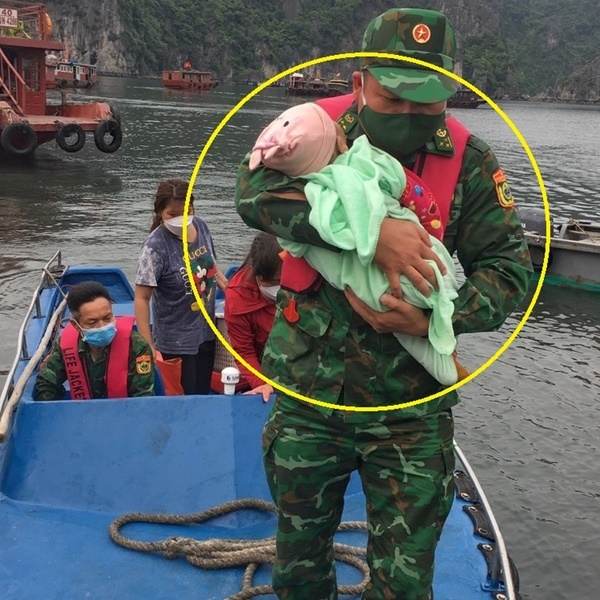  
Em bé được lực lượng chức năng đưa vào bờ an toàn. (Ảnh: Thanh Niên)