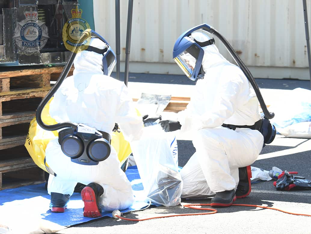 Forensic officers wore protective bio hazard suits during the delicate and complex task of removing the powder from the lathe
